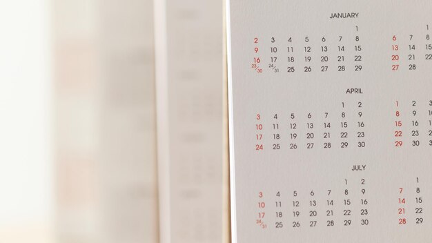 Close up calendar page dates and month background business\
planning appointment meeting concept