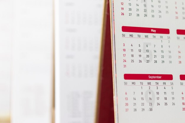 Close up calendar page dates and month background business planning appointment meeting concept