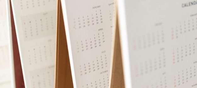 Close up calendar page dates and month background business\
planning appointment meeting concept