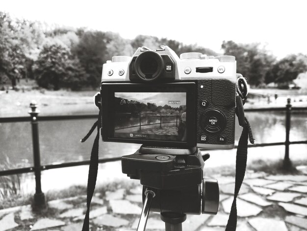 Close-up of camera against cloudy sky