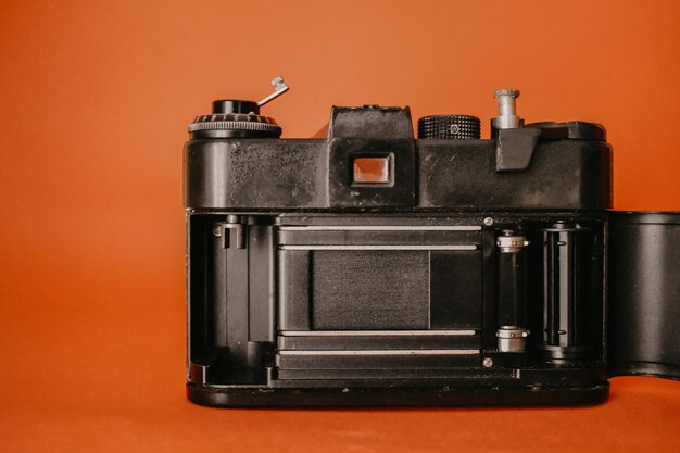 Close-up of camera against orange background