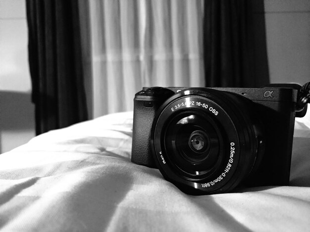 Close-up of camera on bed at home