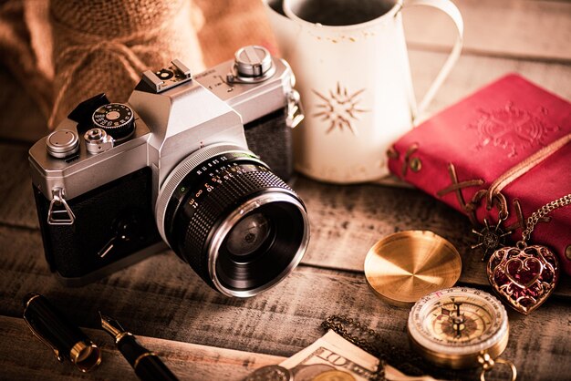 Close-up of camera by compass on table