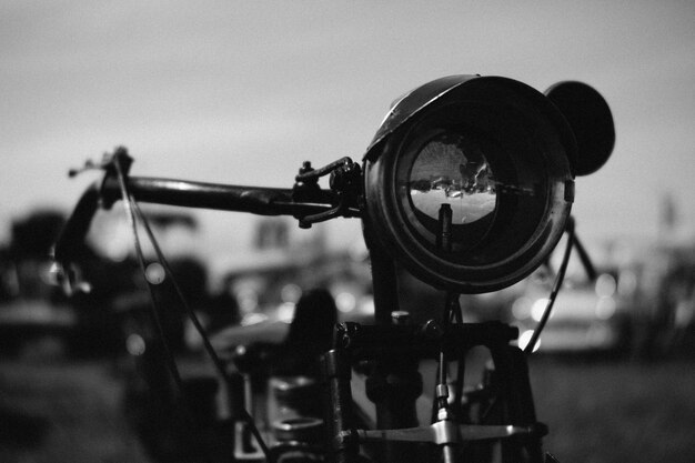 Photo close-up of camera on field against clear sky