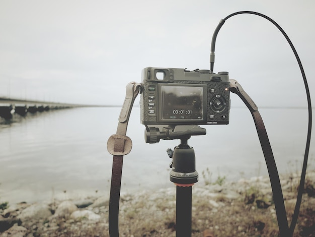 Close-up of camera on shore against sky