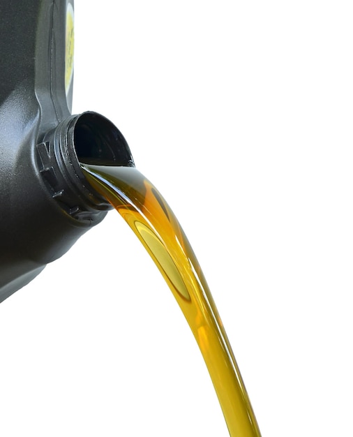 Photo close-up of can pouring oil against white background