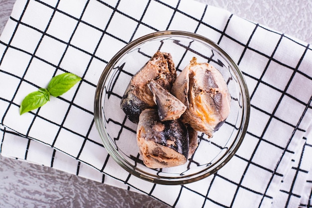 Close up of canned tuna chunks in a bowl on the table top view