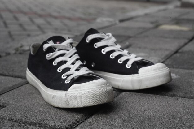 Close-up of canvas shoes on footpath