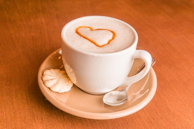 Close-up of cappuccino with coffee on table