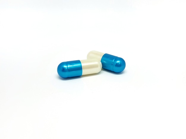 Photo close-up of capsules over white background