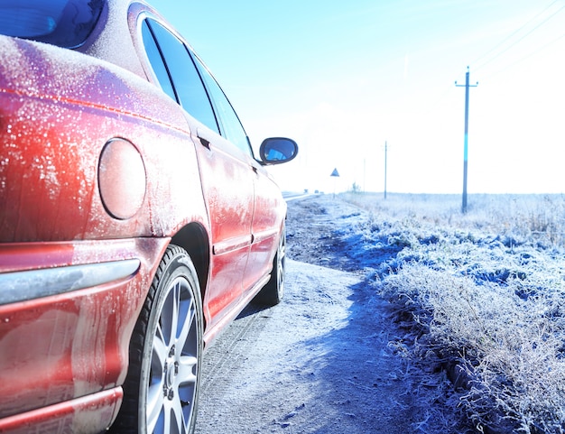 Close up of car on road covered hoarfrost