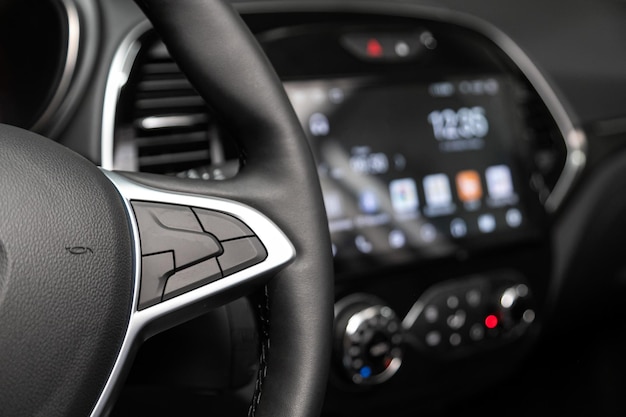 Photo close up of car steering wheel with function buttons