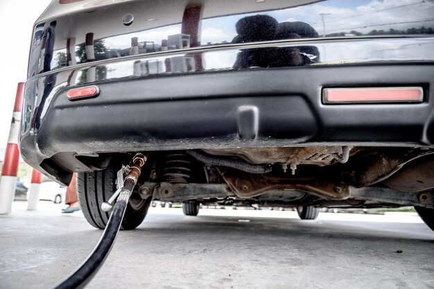 Close-up of car with pipe on road