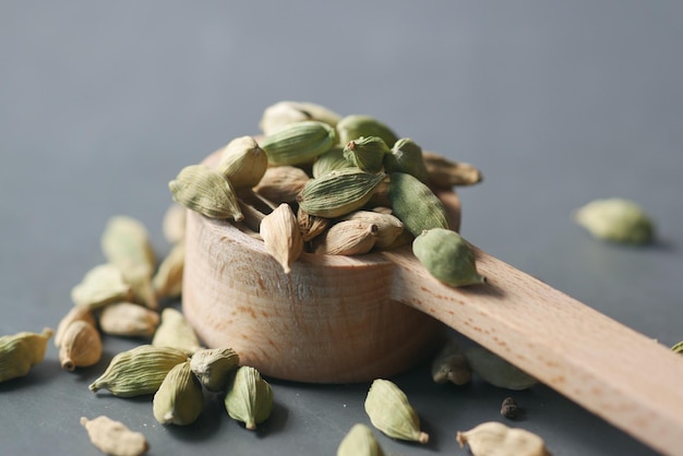 Close up of cardamom on a spoon on table