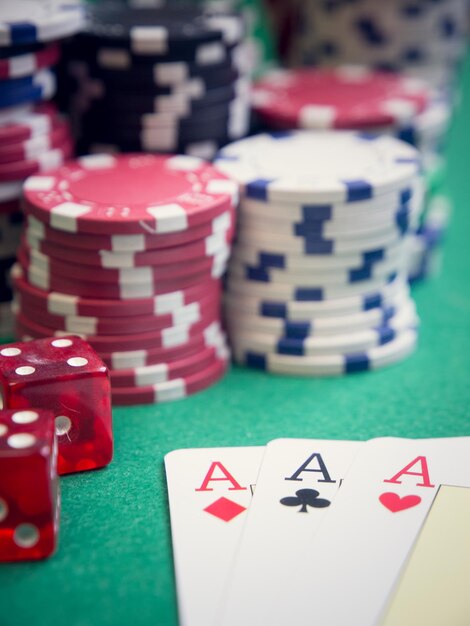 Close-up of cards by gambling chips on casino table