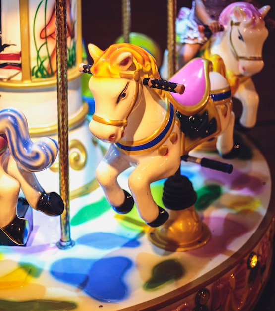 Close-up of carousel horses at night