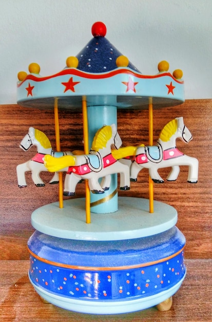 Photo close-up of carousel toy on table