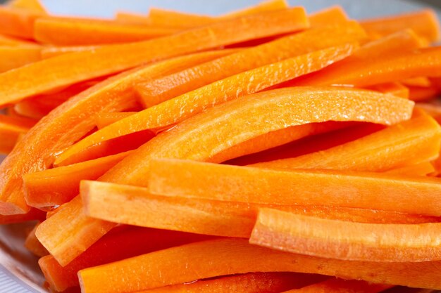 Close up of carrot sticks wet in olive oil