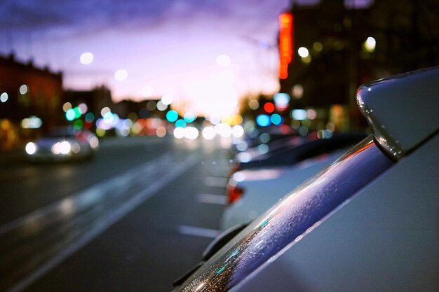 Close-up of cars on road in city at night