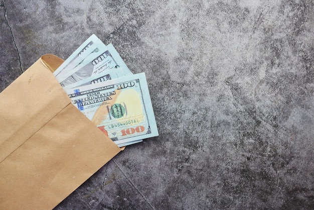 Close up of cash and coins in a envelope on table