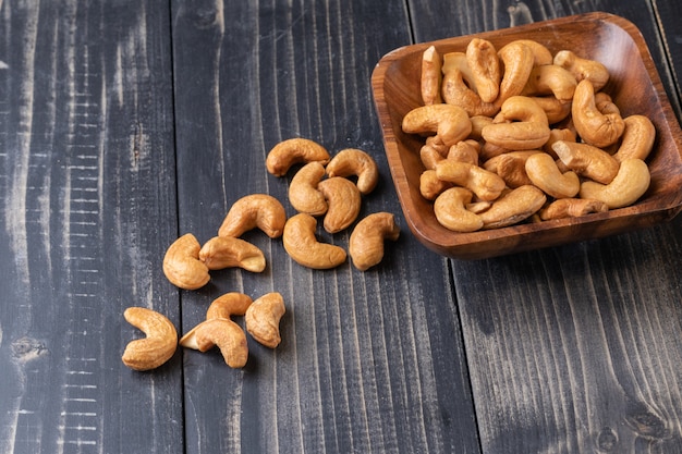 Close up of Cashew nut on wooden bowl