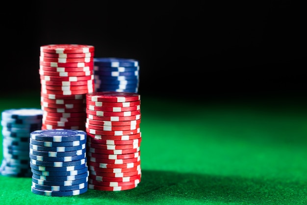 Close up of casino chips on green table surface