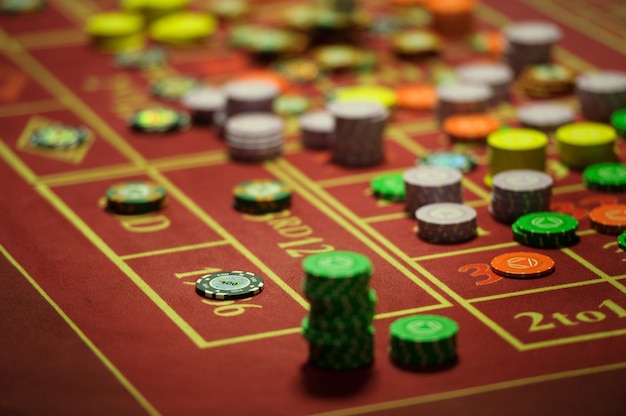 Close-up of casino chips on the red table