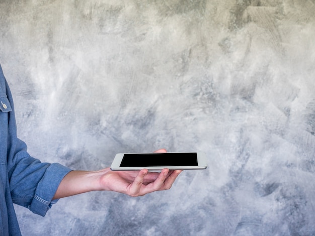 Close up of Casual man hand holding a tablet, communication concept, Free space for text