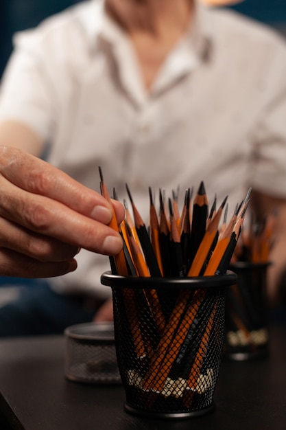 Close up of caucasian hand on colorful pencils for fine art