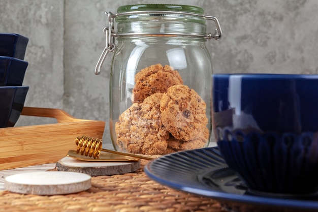 Close up of ceramic tea cup with cookies. Kitchen table