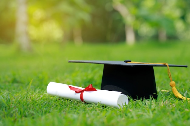 Close up certificate paper and education cap on green grass
springtime in the outdoor park