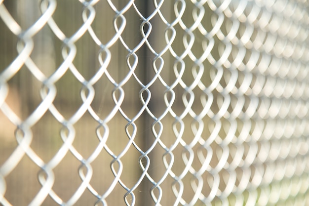 Photo close up chain fence. metal mesh .  white tone