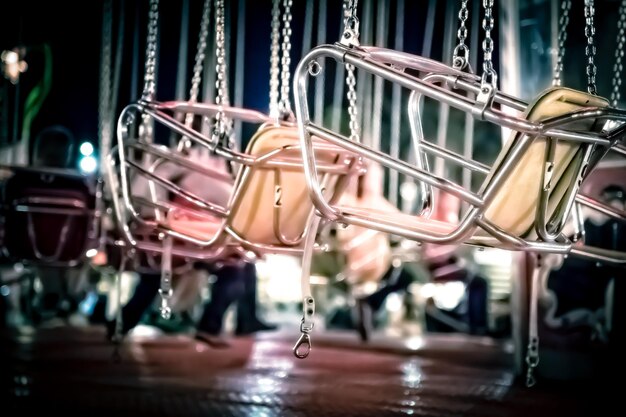 Photo close-up of chain swing ride seats