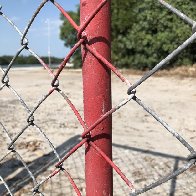 Close-up of chainlink fence in field