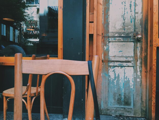 Close-up of chairs by closed door