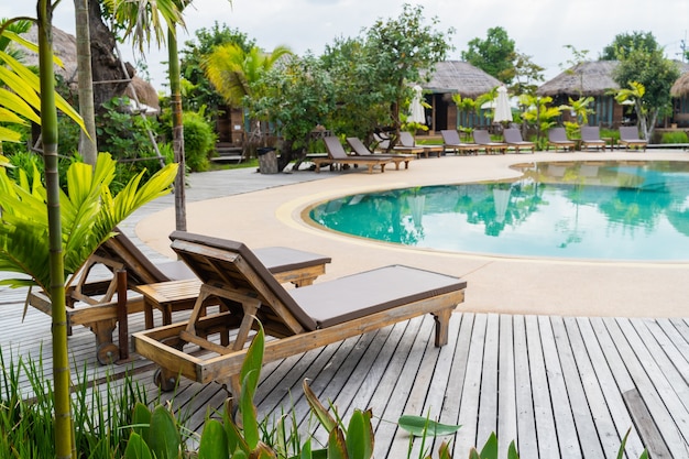 Close up of chairs at the pool in the resort of thailand