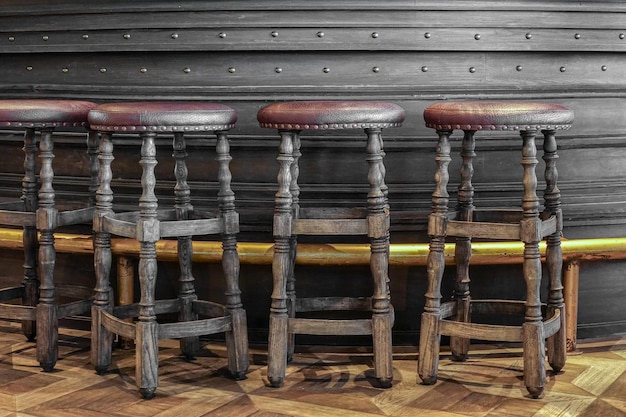 Close-up of chairs on table against wall