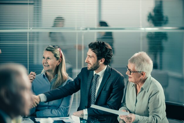 Close up. a cheerful businessman greeting his business partner. business concept