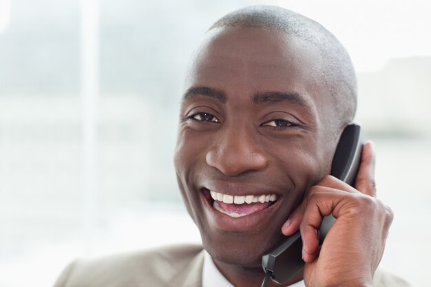 Close up of a cheerful businessman on the phone