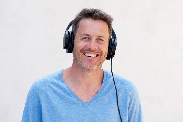 Close up cheerful man with headphones listening to music