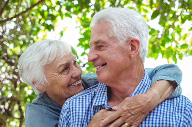 Close-up of cheerful senior couple hugging 