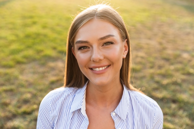 Close up of a cheerful young woman at the park