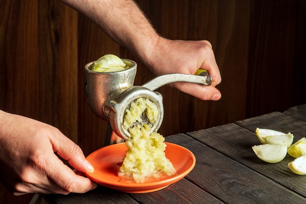 Close-up of a chef's hands preparing food. T