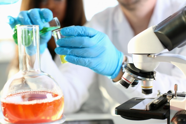 Close up on chemist hands combining various liquids