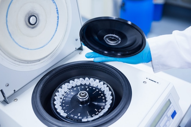 Close up of a chemist using a centrifuge