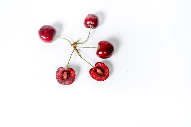 Photo close-up of cherries against white background