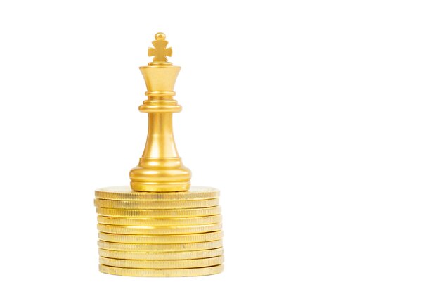 Photo close-up of chess piece on coins against white background