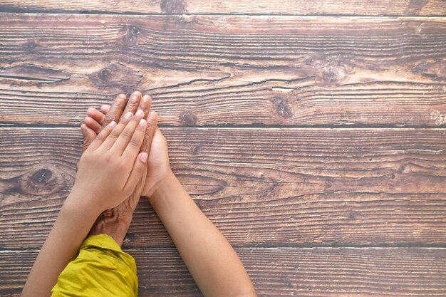 close up of child hand holding senior womens hand