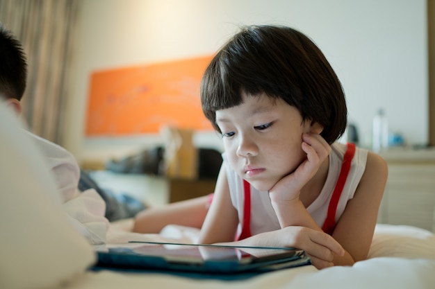 Close up on child playing on the tablet