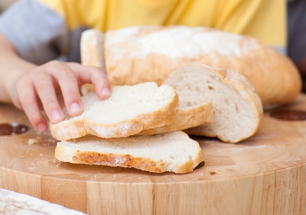 Close-up of child taking some bread